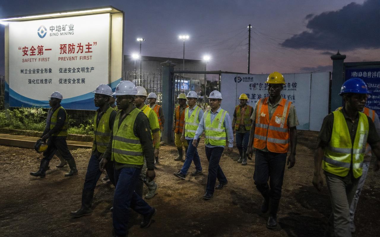 Workers and visiting delegates at a large mechanised gold processing plant in eastern Uganda